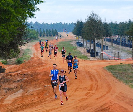 A race along a winding clay dirt road at Cherrylake’s tree farm.